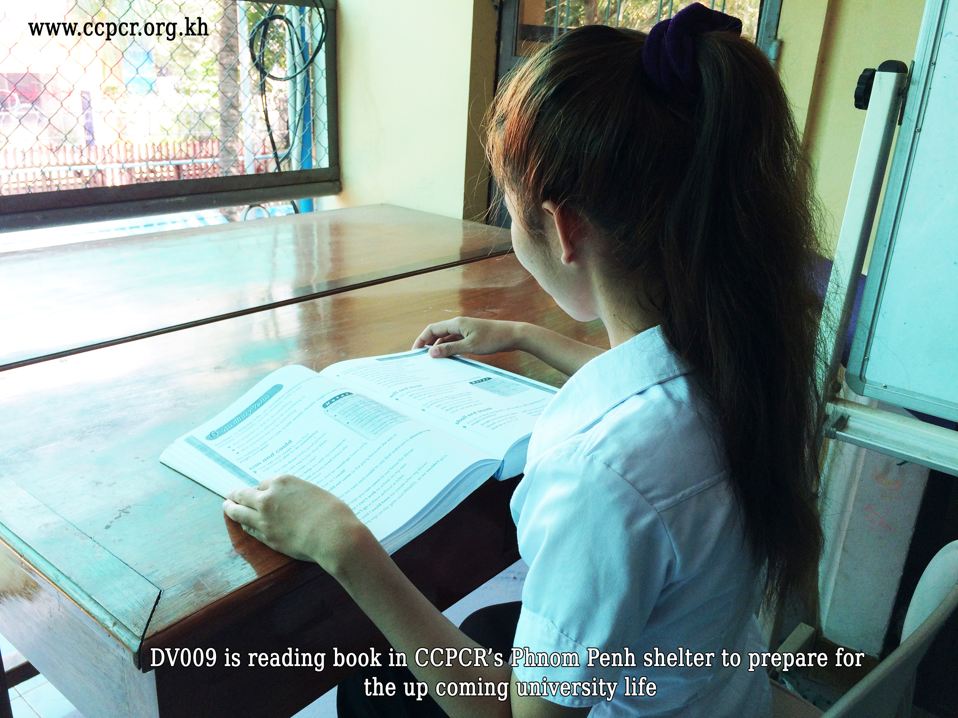 Child is reading in CCPCR's Phnom Penh Shelter